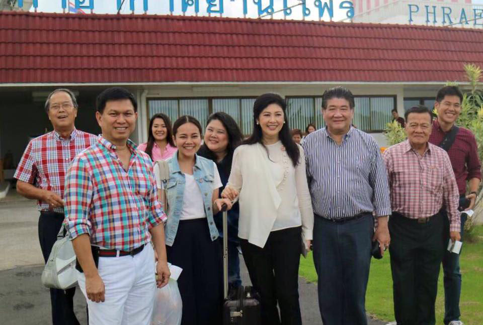 Former Prime Minister Yingluck Shinawatra and her group pose for a photo prior to boarding a plane Sunday in Phrae province. Photo: Yingluck Shinawatra / Facebook