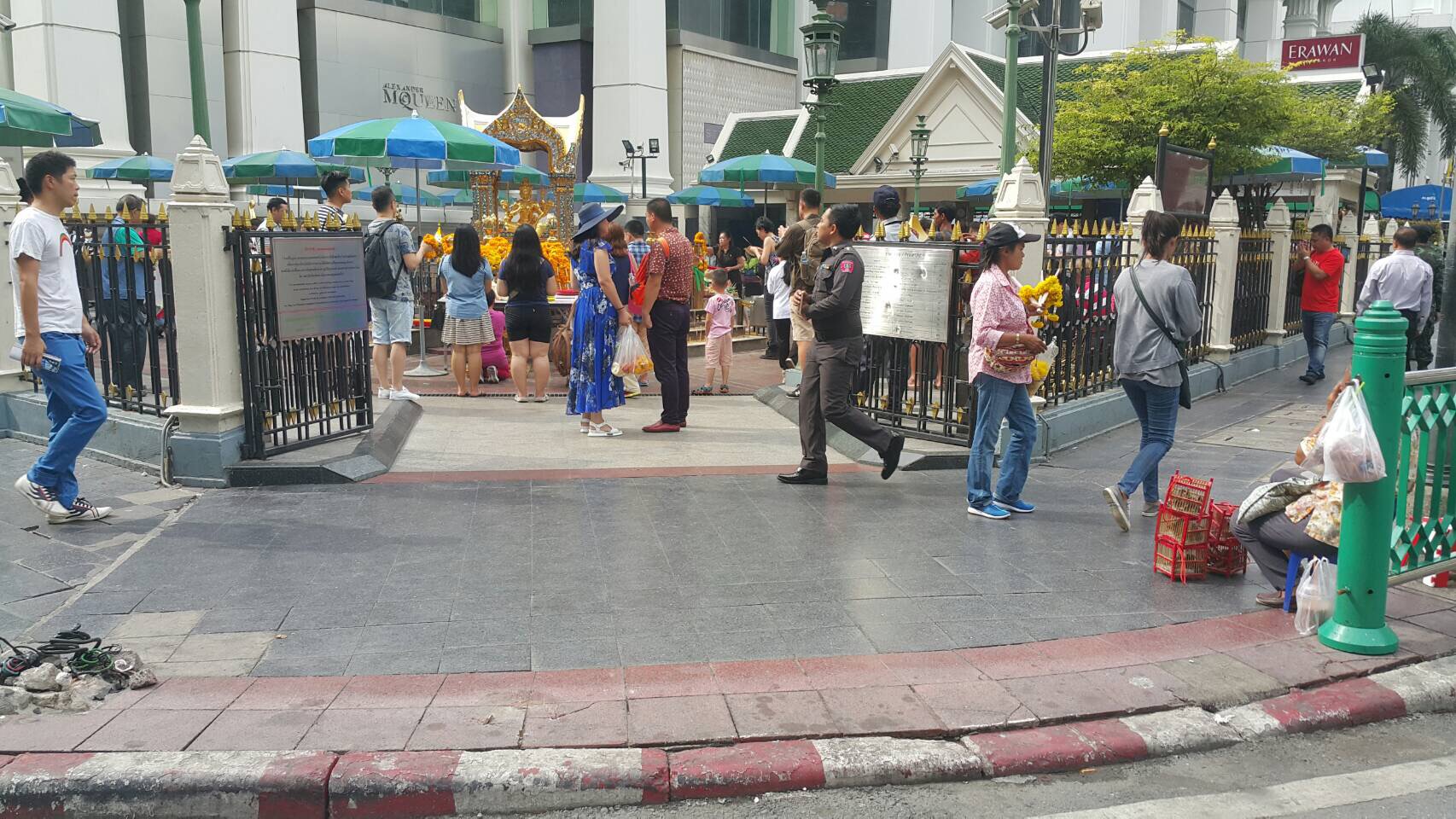 People visit and pray at Bangkok’s Erawan Shrine on Saturday morning.
