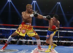 Amnat Ruenroeng, at left, trades punches with China's double Olympic gold medalist Zou Shiming during their IBF flyweight title belt boxing match March 7, 2015, in Macau. Photo: Kin Cheung / Associated Press