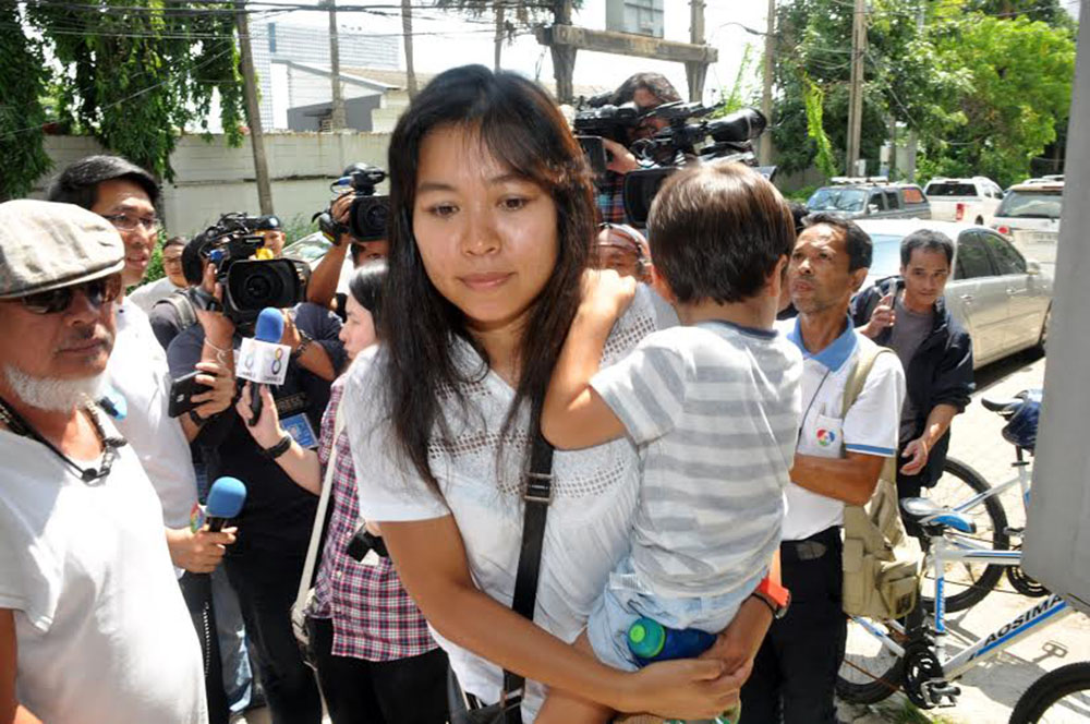 Noppawan Bunluesilp and her 3-year-old son as they were taken Friday to the Crime Suppression Division in Bangkok.