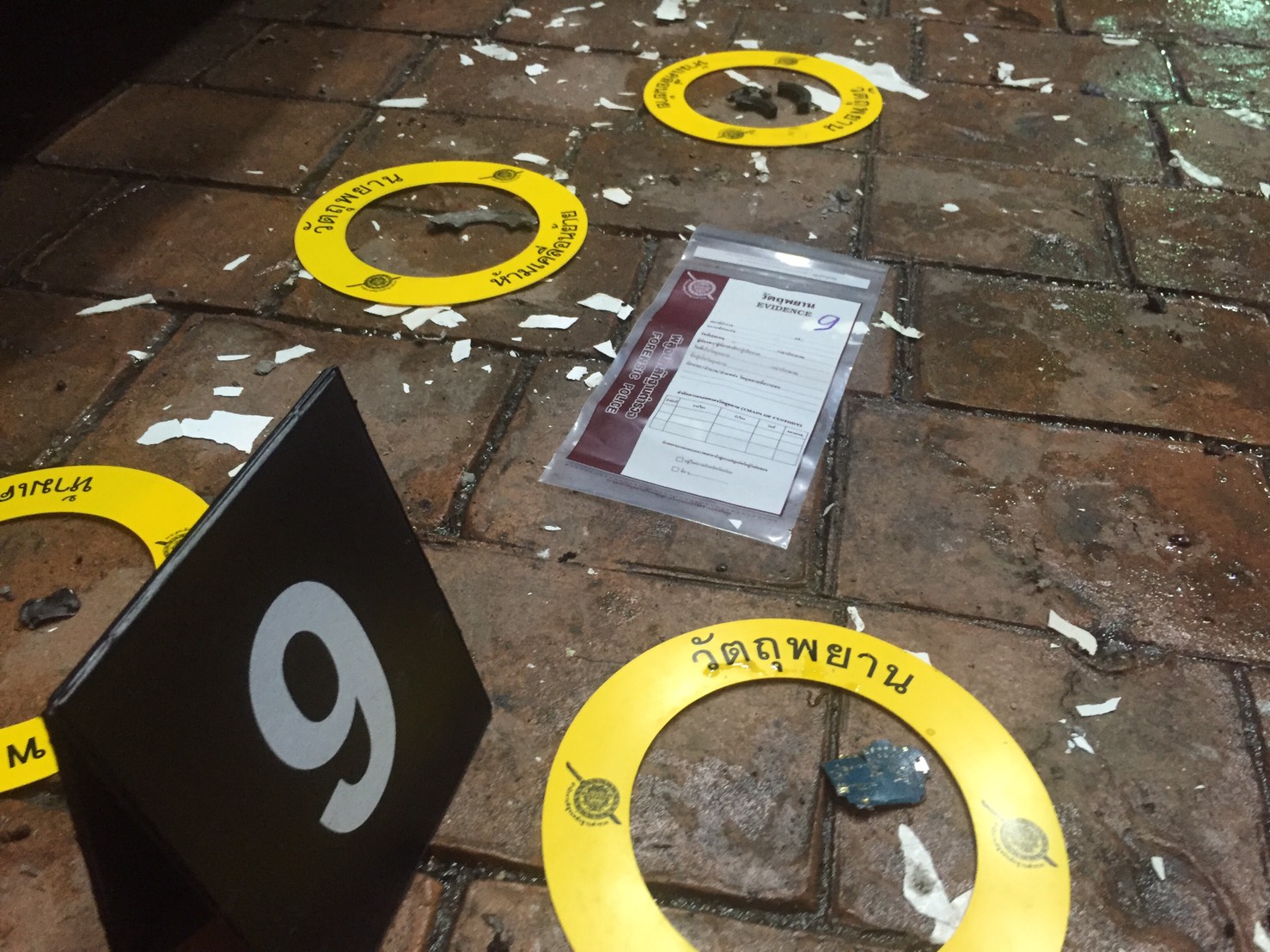 Investigators night mark evidence Thursday night at one of two bombing sites in the resort town of Hua Hin.