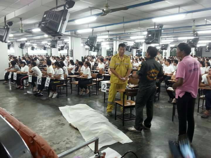 Rescue workers prepare to remove the body of Kobchai Pureprasert, 39, from an examination room Sunday at Ramkhamhaeng University in Bangkok.