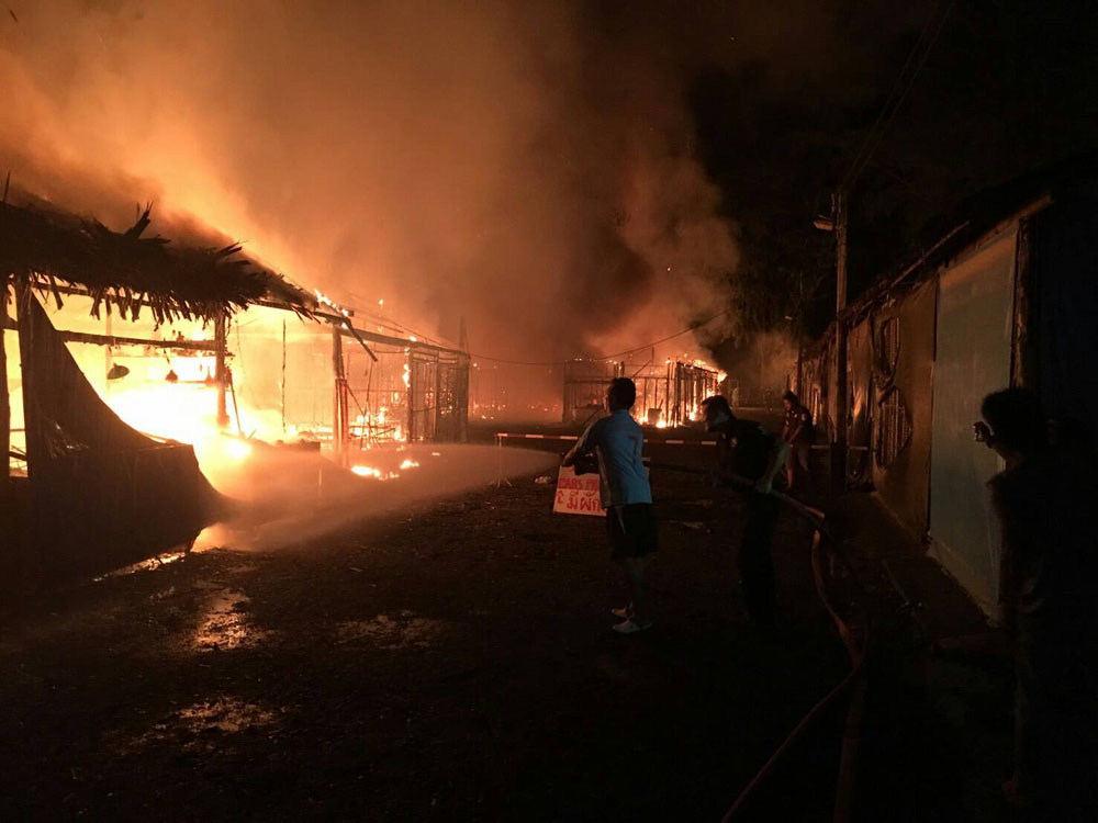 Firefighters work to put out a fire early Friday morning at the Bang Niang Market in Phang Nga province.