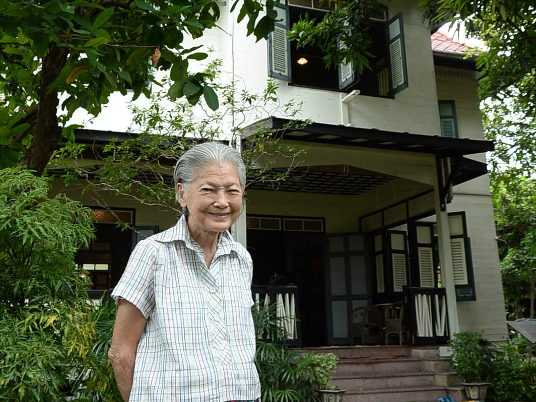 Waraporn Surawadee standing in front of her house which was donated to Bangkok Metropolitan Administration to be local museum.