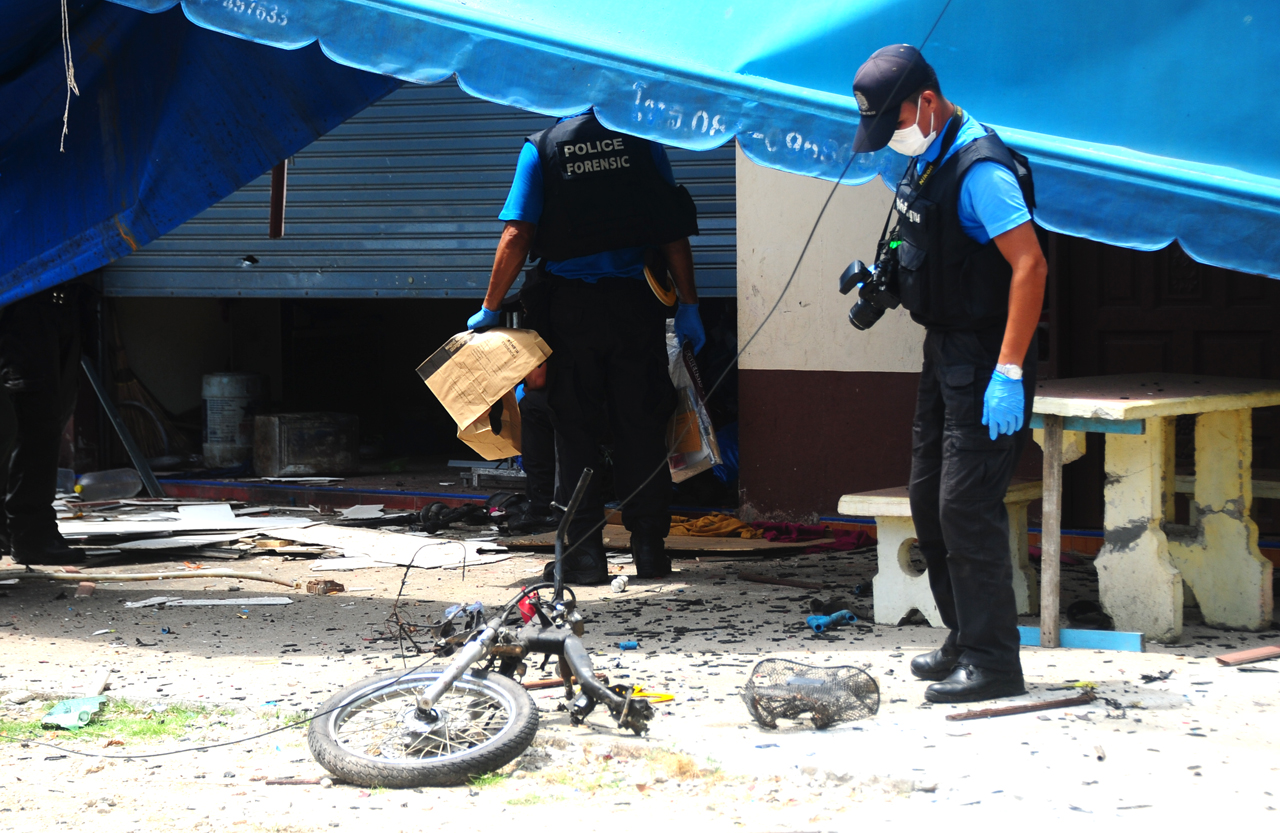 Police on Tuesday inspect wreckage of a motorcycle bomb that exploded in front of Ban Ta Ba School in Pattani province, killing two people.