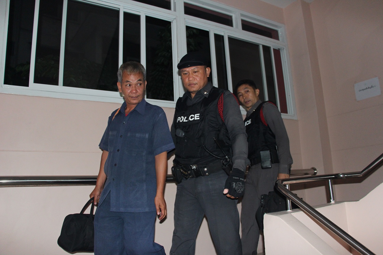 Police escort Add Surawat from the condominium Sunday night where he allegedly assaulted his niece in Bangkok’s Phra Khanong district.