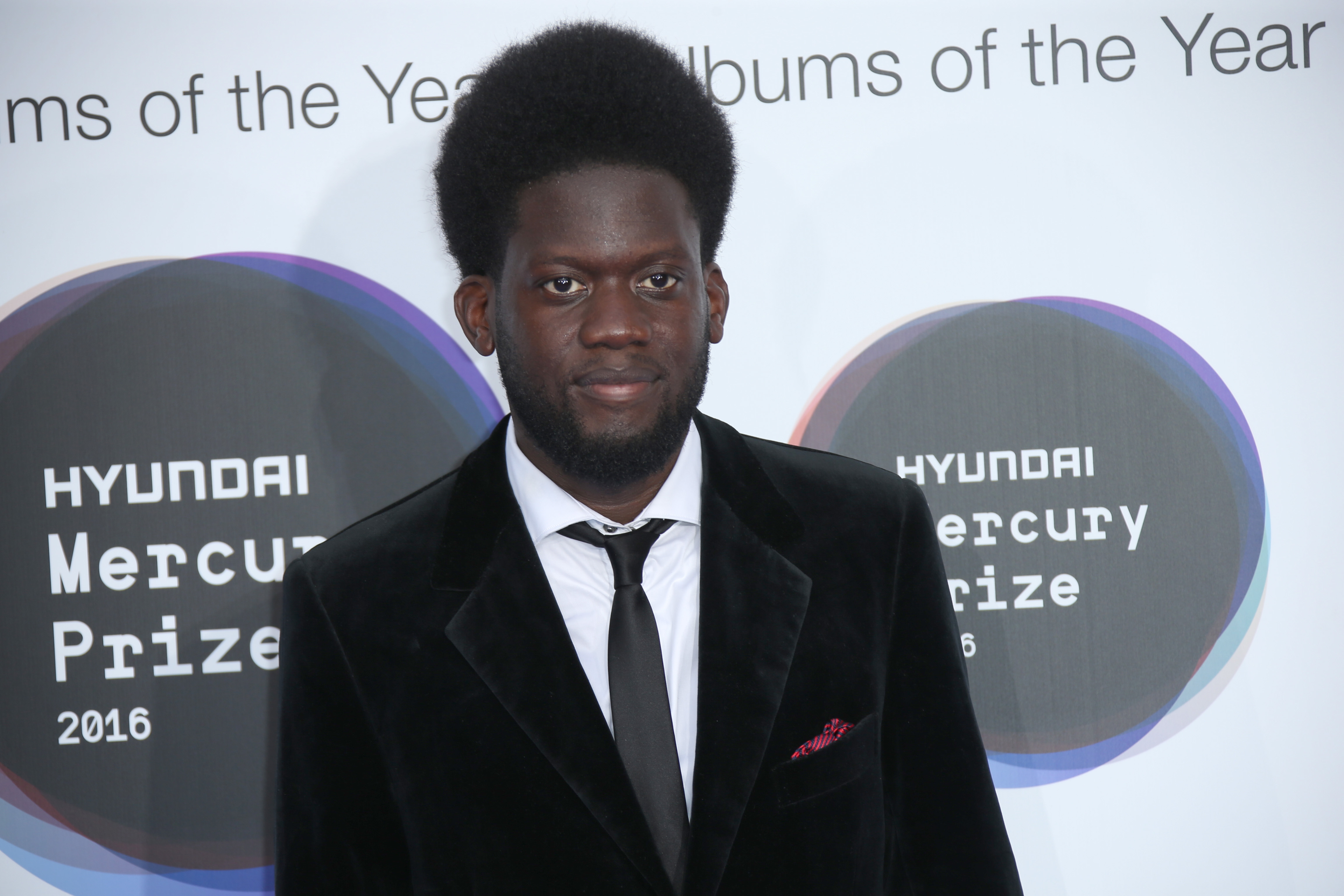 Singer Michael Kiwanuka poses for photographers upon arrival at the Mercury Prize Albums of the Year event in London. (Photo by Joel Ryan / AP)