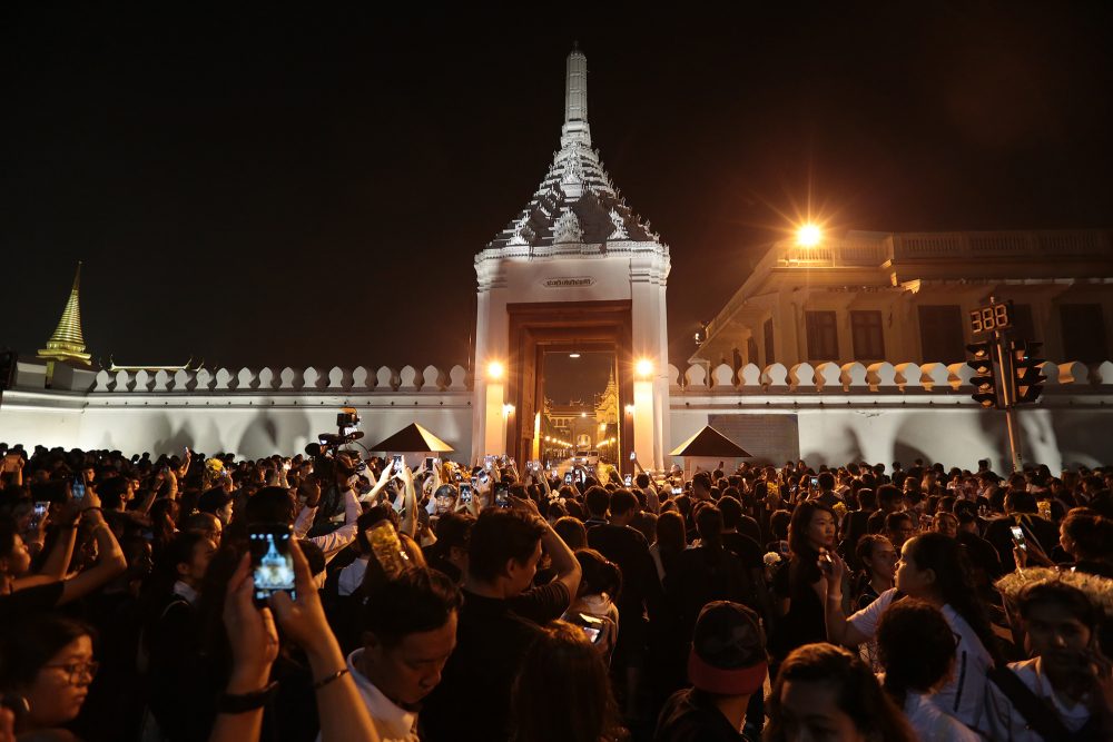 Mourners gather outside the Wiset Chaisri Gate on Tuesday at the Grand Palace in Bangkok.
