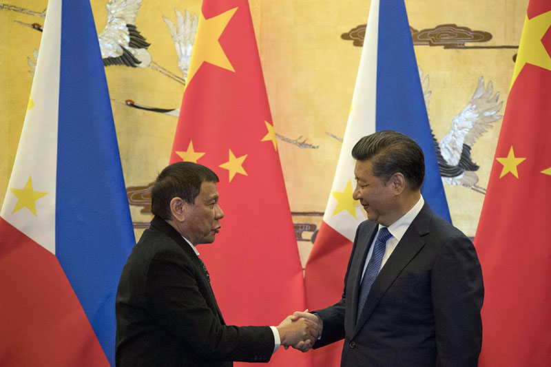 Philippine President Rodrigo Duterte, at left, and Chinese President Xi Jinping shake hands in 2016 after a signing ceremony in Beijing. Photo: Ng Han Guan / Associated Press Philippine President Rodrigo Duterte, at left, and Chinese President Xi Jinping shake hands in 2016 after a signing ceremony in Beijing. Photo: Ng Han Guan / Associated Press
