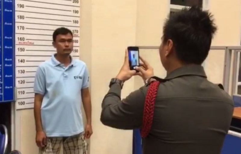 Jeeradech Charoentut, 40, poses for a mug shot Tuesday night at the Phra Khanong Police Station in Bangkok.