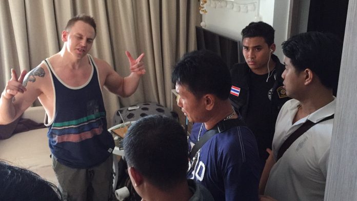 Marcus Sten Tapio Karhapaa, 34, gestures while talking to police Tuesday in Pattaya.