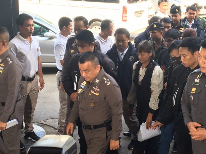 Police at the Crime Suppression Division escort eight suspects Sunday accused of involvement with a multi-level marketing scam that left more than a 1,000 travelers stranded at Suvarnabhumi Airport earlier this month.