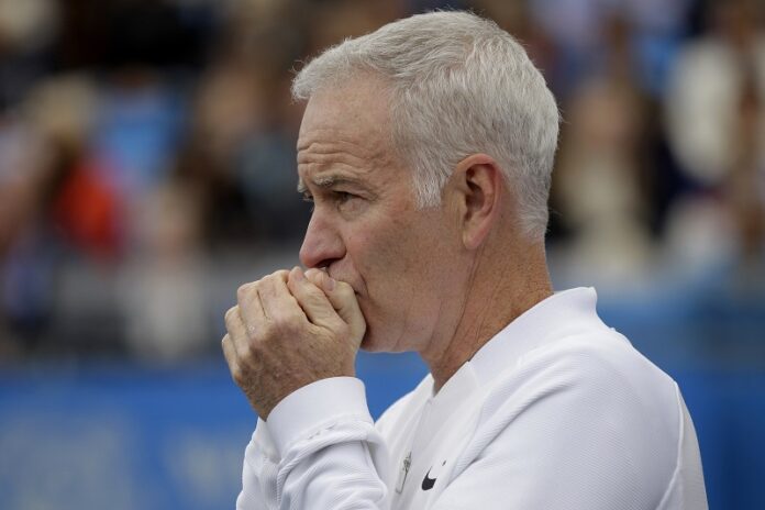 A 2016 photo file of John McEnroe, Coach to Canada's Milos Raconic, looks across the court as Raconic plays Australia's Bernard Tomic during their semifinal tennis match on the sixth day of the Queen's Championships London. Photo: Tim Ireland