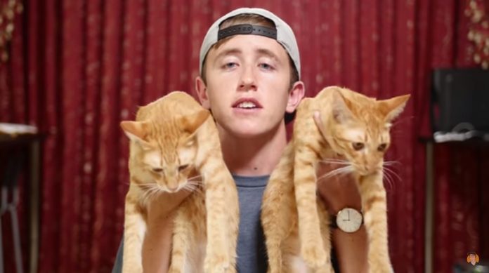 Nate Bartling holds up his cats in a video released Saturday defending a prank video released last week that resulted in a criminal complaint of animal cruelty. Photo: My Mate Nate / YouTube