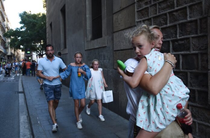 People flee the scene in Barcelona, Spain, on Thursday after a white van jumped the sidewalk in the historic Las Ramblas district, crashing into a summer crowd of residents and tourists and injuring several people, police said. Photo: Giannis Papanikos / Associated Press