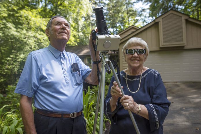 Donald and Norma Liebenberg stand in the driveway of their home in Salem, South Carolina, on Thursday. Donald has seen and blogged about his 26 eclipses for Clemson University where he does research, and holds the record for most time in totality because the retired federal scientist used to chase them by airplane whenever possible. In 2017, the celestial event will come to him. Photo: Ken Scar / Clemson University