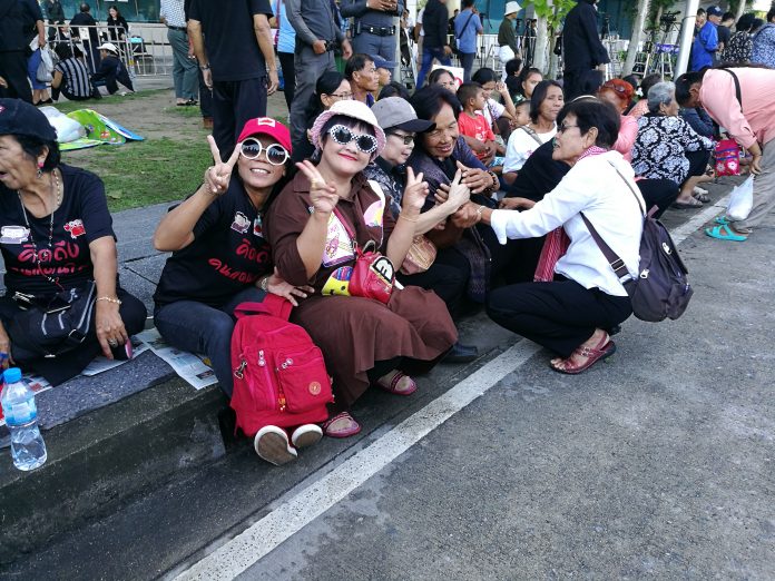 Supporters seated outside the Supreme Court's political division on Wednesday morning in Bangkok.