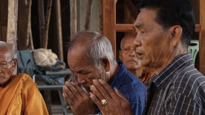 Juthaporn Oun-on’s family makes merit Sunday at a religious ceremony in Sisaket province.