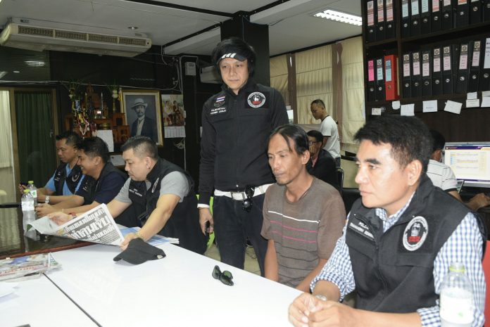 Suspect Neung Tongbao, 39, seated in brown, Tuesday at the Pattaya City Police Station.