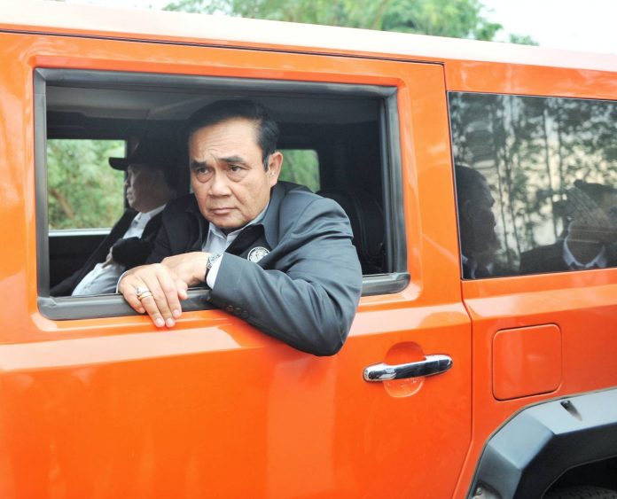 Junta chairman Prayuth Chan-ocha looks out of a car window Tuesday during a trip to Khon Kaen province