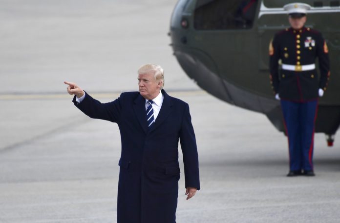 President Donald Trump gestures as he walks towards Air Force One at John F. Kennedy International Airport in New York, Saturday, Dec. 2, 2017. Trump spent the day in New York attending a trio of fundraisers. (Susan Walsh/Associated Press)