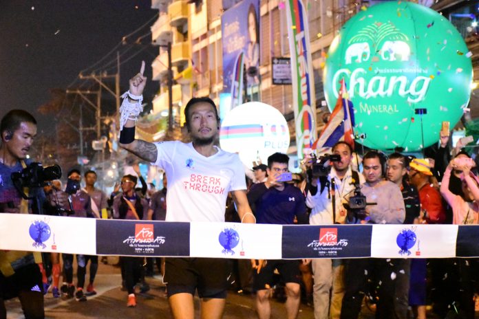 Artiwara Kongmalai or Toon Bodyslam runs to the finish line of his cross-country charity run Monday in Chiang Rai province.