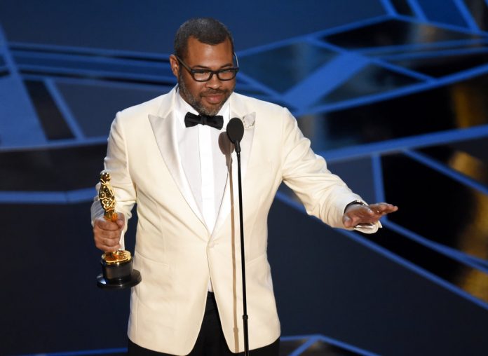 Jordan Peele accepts the award for best original screenplay for