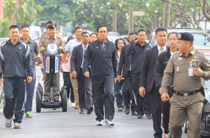 Junta chairman Prayuth Chan-ocha takes a walk around Government House on Wednesday