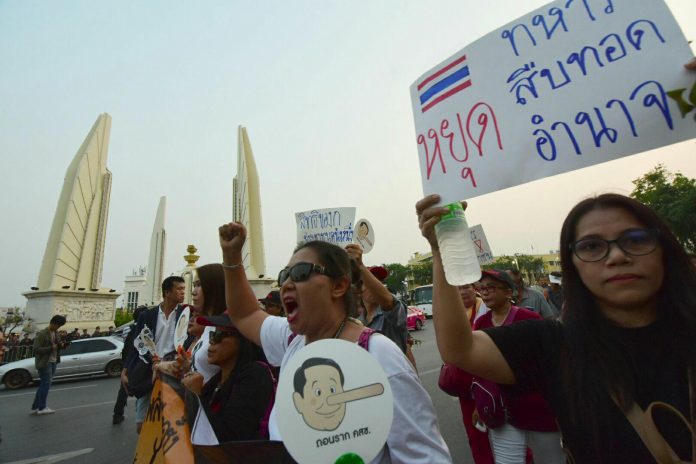 Pro-election demonstrators march on Ratchadamnoen Avenue on March 24