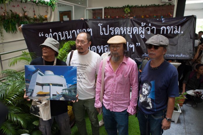 Artists including Manit Sriwanichpoom, in white, and Vasan Sitthiket, in pink, submit a complaint opposing City Hall’s takeover of the Bangkok Art and Culture Centre on Monday morning at the Government House. Photo: Wannaphon Chimbanchong / Courtesy
