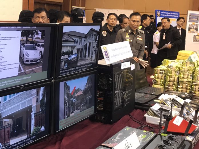 Police show off computers, cash, sports cars and other assets they seized from AlphaBay founder Alexandre Cazes on July 24.