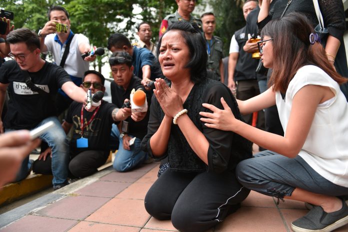 Rewadee Tanlahasuntorn cries Wednesday at the Criminal Court where her husband killed himself.