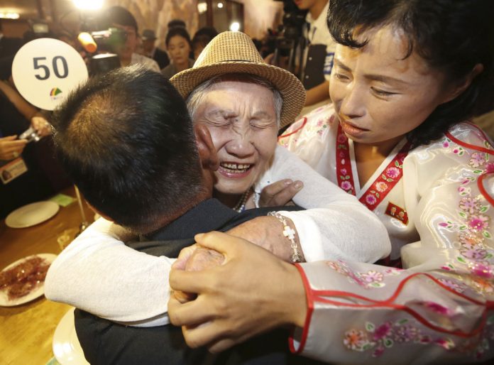 South Korean Lee Keum-seom, 92, on Monday hugs her North Korean son Ri Sang Chol, 71, left, with Kim Ok Hui, daughter-in-law of Ri Sang Chol during the Separated Family Reunion Meeting at the Diamond Mountain resort in North Korea. Photo: Lee Ji-eun / Yonhap via AP