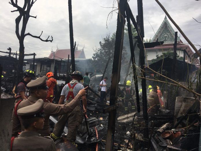 Police and firemen inspect the scene of a fire Friday morning that destroyed 16 homes in Bangkok's western district of Bangkok Yai. Police and firemen inspect the scene of a fire Friday morning that destroyed 16 homes in Bangkok's western district of Bangkok Yai.