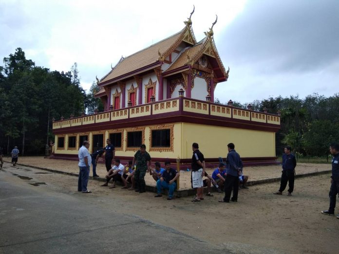 Authorities seen Saturday morning at the Rattana Nuphap Temple, hours after an attack that killed at least two monks.