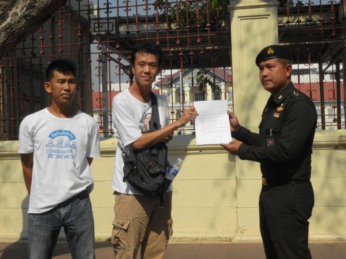 Ekachai Hongkangwan hands a letter to an army representative. Image: Ekachai Hongkangwan / Facebook