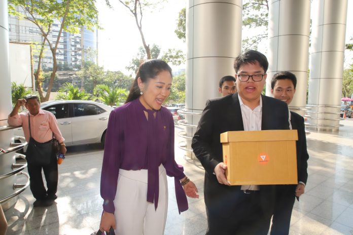 Pannika Wanich, spokeswoman for the Future Forward Party, arrives Wednesday at the Criminal Court with evidence to present.