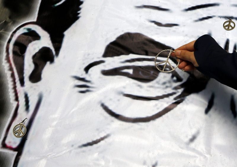 A Thai protester puts peace signs on a caricature of junta leader General Prayuth Chan-ocha during an anti-coup demonstration at a shopping mall in Bangkok, Thailand, 01 June 2014. General Prayuth revealed on Saturday a schedule of reforms and interim government that ie expected to lead to general elections by late 2015. EPA/RUNGROJ YONGRIT