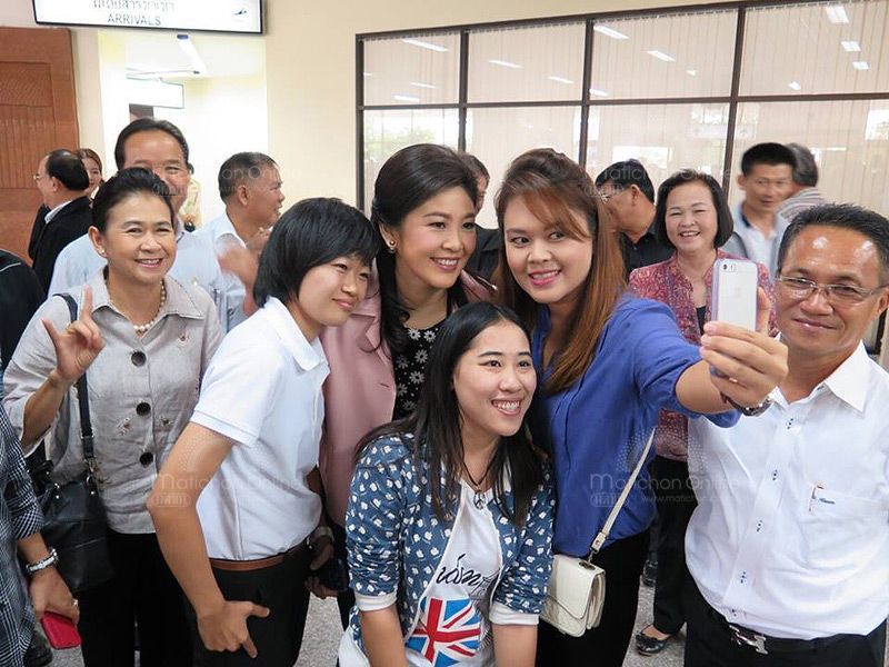 Former Prime Minister Yingluck Shinawatra with passengers at Bangkok's Suvarnabhumi Airport, 8 September 2014.