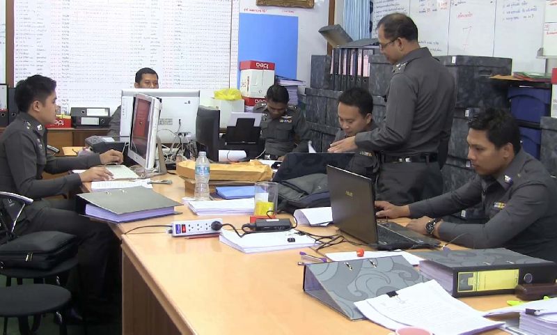 Police officers processing the case files for suspected human traffickers in Songkhla province on 30 June.