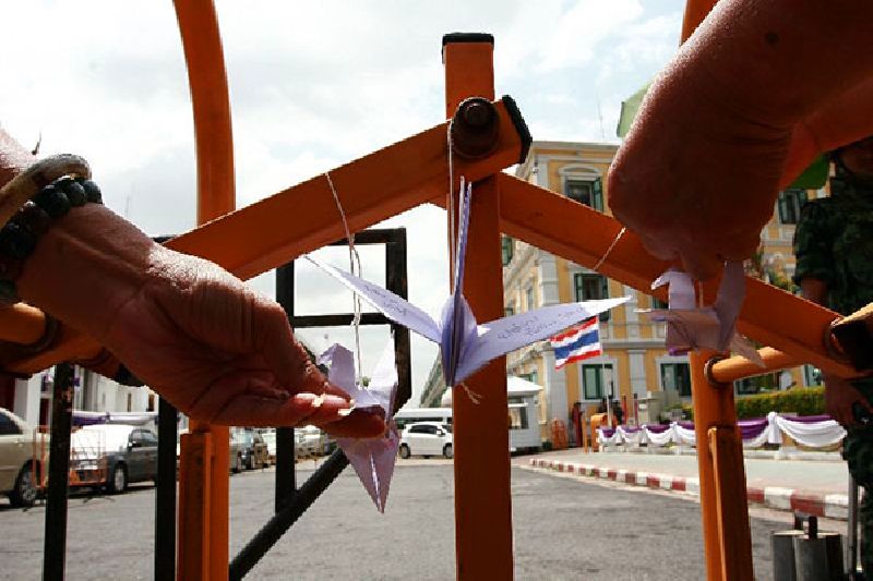 Pro-democracy activists hang cranes outside Bangkok's martial court on 7 July 2015.