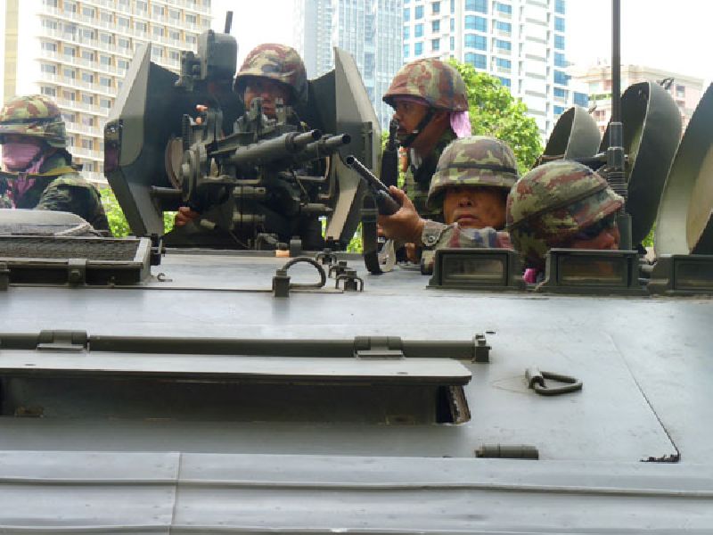 Soldiers perch atop an armored personnel carrier as it rolls into Lumpini Park on 19 May, 2010, where a fortified encampment had been erected by protesters. Photo: Todd Ruiz