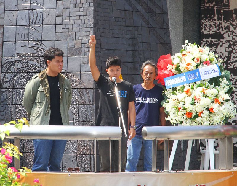 An activist from the Dao Din pro-democracy group flashes the 'three-finger salute' adopted by activists from the 'Hunger Games' films at a ceremony today marking the 42nd anniversary of the uprising on October 14, 1973.