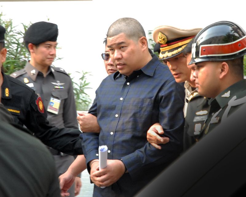 Police officers escort Police Maj. Prakrom Warunprapha to the martial court in Bangkok on Oct. 21, 2015