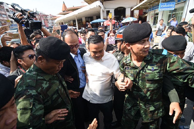 Jatuporn Prompan is led away from a news conference Monday morning southwest of Bangkok in Samut Sakhon province.