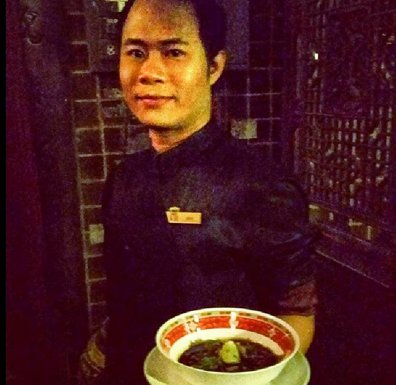 One of the staff at Maggie Choo's holding dumplings.
