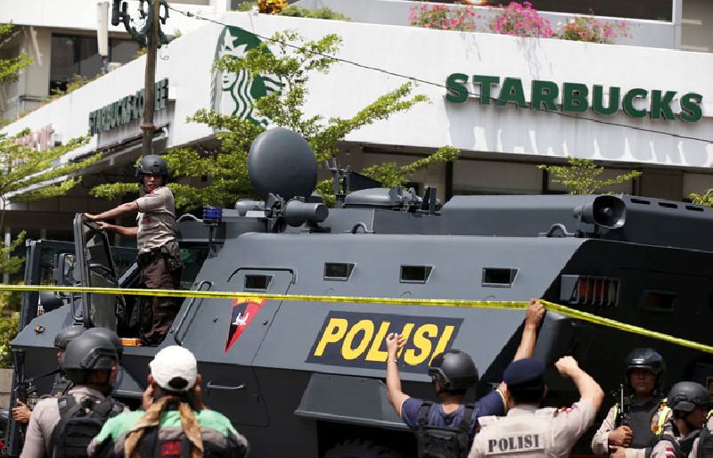 A police vehicle sits outside a Starbucks in Jakarta near the scene where suicide bombers and gunmen attacked Thursday. Photo: Darren Whiteside / Reuters