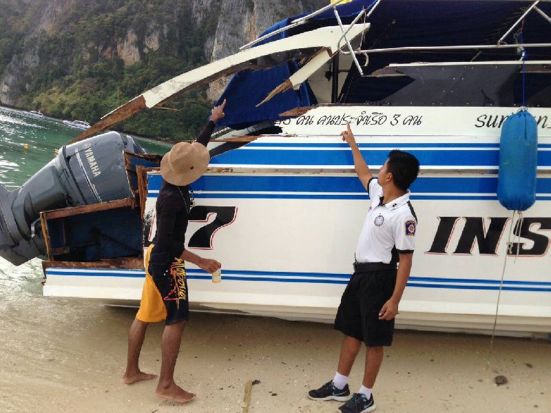 An officer points out damage Thursday to the rear end of the speedboat Bantita 9.