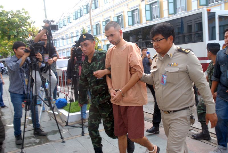 Bombing suspect Adem Karadag led Oct. 19 into the military court in Bangkok.<br />