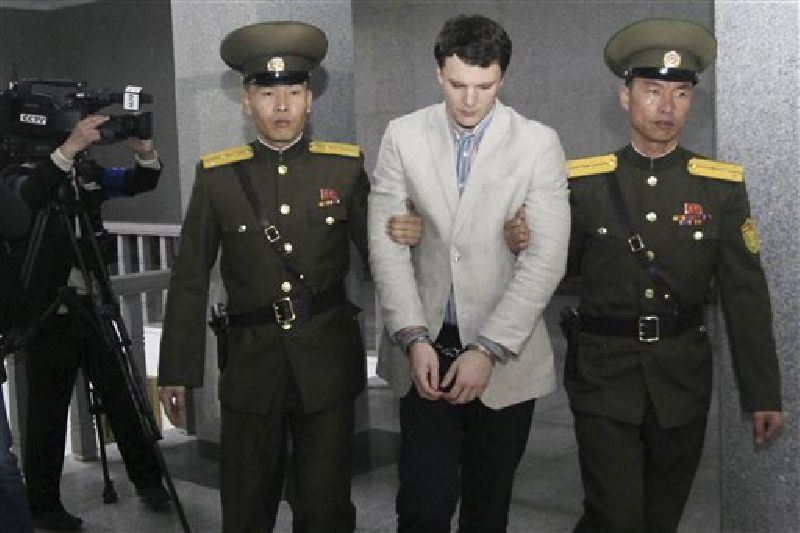 American student Otto Warmbier, center, is escorted at the Supreme Court in Pyongyang, North Korea, Wednesday, March 16, 2016. Photo: Jon Chol Jin / Associated Press